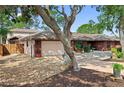 Charming single-story home with a well-maintained lawn, mature trees, and attached two-car garage at 5496 S Nova Rd, Port Orange, FL 32127