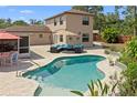 Inviting backyard pool with lush landscaping and cozy outdoor seating area, perfect for relaxation and entertaining at 5496 S Nova Rd, Port Orange, FL 32127