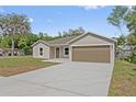 Inviting single-story home with a spacious driveway and well-manicured lawn at 560 Sumner Ave, Orange City, FL 32763