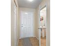 Inviting entryway with tile floors and a glimpse into the half bathroom at 564 Mount Olympus Blvd, New Smyrna Beach, FL 32168