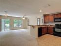 Open-concept living room and kitchen combo with plenty of natural light at 564 Mount Olympus Blvd, New Smyrna Beach, FL 32168