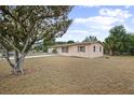 Cozy home with simple architectural lines surrounded by mature trees and green space at 566 S Floyd Cir, Deltona, FL 32725