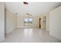 Bright living room with tile flooring, neutral walls, and a welcoming front entrance at 566 S Floyd Cir, Deltona, FL 32725