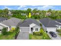 Aerial shot of the home nestled within a vibrant community, boasting manicured lawns and solar panels at 6212 W Fallsgrove Ln, Port Orange, FL 32128