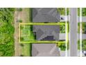 Aerial view showing the property's layout with solar panels, including a defined yard space and neighborhood context at 6212 W Fallsgrove Ln, Port Orange, FL 32128