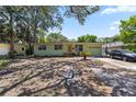 Inviting single-story home with a beautiful lawn, mature tree and front-facing garage at 632 Tarragona Way, Daytona Beach, FL 32114