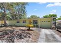 Charming single-story home with a manicured lawn, front-facing garage and mature landscaping at 632 Tarragona Way, Daytona Beach, FL 32114