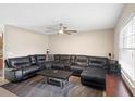 Spacious living room features a comfortable black sectional sofa and a large rug at 6509 Lake Lerla Dr, Apopka, FL 32712