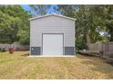 Exterior shot of a metal storage shed with a roll-up door, providing ample space for storage at 6509 Lake Lerla Dr, Apopka, FL 32712