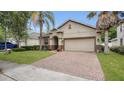 Charming single Gathering house featuring tan siding, arched doorway, and manicured lawn at 680 Preakness Cir, Deland, FL 32724
