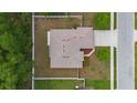 Aerial view of a well-maintained property featuring a durable roof and a spacious driveway at 703 Elkhorn Fern Ln, Deland, FL 32720