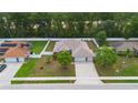 An aerial view of the property showcasing its layout, landscaping, fenced yard and neighborhood at 703 Elkhorn Fern Ln, Deland, FL 32720