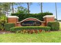 A beautifully landscaped entrance sign for the Heritage Place community creates an inviting welcome at 703 Elkhorn Fern Ln, Deland, FL 32720