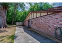 Side view of a brick home featuring a walkway, an exposed AC unit, and connection for a hose at 818 Sugar House Blvd, Port Orange, FL 32129
