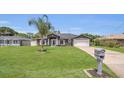 Charming single-story home with landscaped front yard and attached two-car garage at 1194 Balfour Dr, Deltona, FL 32725