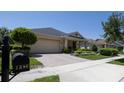 Charming one-story home with a well-manicured lawn, lovely landscaping, and a brick paved driveway at 1386 Brayford Pt, Deland, FL 32724