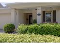 Inviting front porch with lush landscaping, pillars, outdoor seating, and decorative window shutters at 1386 Brayford Pt, Deland, FL 32724