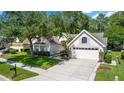Attractive single-Gathering home boasting manicured lawn, ample parking, and mature landscaping at 1412 Bent Oaks Blvd, Deland, FL 32724