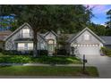 Beautiful home with mature landscaping, a manicured lawn, and a two-car garage at 1412 Bent Oaks Blvd, Deland, FL 32724