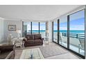 Inviting living room with comfy seating, ocean views, and access to the balcony at 1420 N Atlantic Ave # 202, Daytona Beach, FL 32118