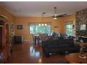 Open concept living room and dining area featuring hardwood floors and a stone fireplace at 1725 Turtle Hill Rd, Enterprise, FL 32725