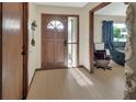Inviting foyer with wood-look floors, a secure front door, and seamless flow to the rest of the home at 1904 Viking Ave, Deltona, FL 32725