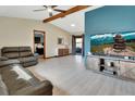 Bright living room with vaulted ceiling, modern furniture, and sliding glass doors to the outdoor space at 1904 Viking Ave, Deltona, FL 32725