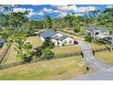 Aerial view of home with fenced yard, mature trees, and a long driveway at 19343 Moorgate St, Orlando, FL 32833