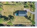 Aerial view of home with fenced yard, mature trees, and screened pool at 19343 Moorgate St, Orlando, FL 32833