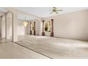 Spacious living room with a chandelier, large windows, and a comfortable carpeted area at 200 Gala Cir, Daytona Beach, FL 32124