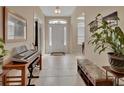 Inviting foyer with neutral-toned walls, tile flooring, and natural light streaming through the front door at 2004 Quail Hollow Dr, Deland, FL 32720