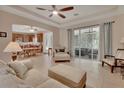 Comfortable living area with a ceiling fan, tile floors, and sliding doors leading to the lanai at 2004 Quail Hollow Dr, Deland, FL 32720