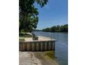 Scenic waterfront view with a bench and lush trees offers a peaceful setting at 2004 Quail Hollow Dr, Deland, FL 32720