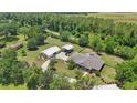 Wide aerial view of home with two garages surrounded by mature trees and landscaping at 226 Treeline Ln, Ormond Beach, FL 32174