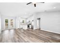 Open-concept living space with kitchen, stainless steel appliances, and outdoor patio access at 2379 8Th Ave, Deland, FL 32724