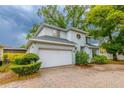 A two-story home with a two car garage and a brick paver driveway at 2418 Formosa Ave, Orlando, FL 32804