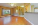 Inviting living room with hardwood floors, a ceiling fan and a glimpse of the staircase at 2418 Formosa Ave, Orlando, FL 32804