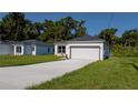 A charming single-story house with a well-kept lawn and a two-car garage on a sunny day at 248 S Virginia Ave, Deland, FL 32724