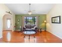 Inviting living room featuring hardwood floors, a comfortable seating area, and a large window at 25 Pine Glen Dr, Debary, FL 32713