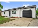 A well-maintained single-Gathering home featuring a paved driveway, attached garage, and freshly landscaped front yard at 2517 Oak Hollow Dr, Kissimmee, FL 34744