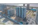 Aerial view of a high-rise condo building next to beach with in-ground pool at 3003 S Atlantic Ave # 17A1, Daytona Beach Shores, FL 32118