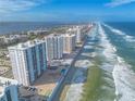 Aerial view of tall condo buildings on a sunny beach with ocean views at 3003 S Atlantic Ave # 17A1, Daytona Beach Shores, FL 32118