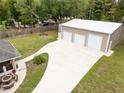 Spacious three-car garage with a paved driveway and well-manicured lawn; perfect for car enthusiasts at 3210 Whitehorse Ct, Deltona, FL 32738