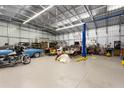 Large garage interior equipped with a car lift and ample space for tools and vehicles at 3210 Whitehorse Ct, Deltona, FL 32738