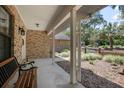 Relaxing front porch with brick columns and a comfortable bench at 3357 Black Willow Trl, Deland, FL 32724