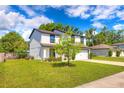 Corner view of a two-story home featuring a lush green lawn, and well maintained landscaping at 348 Southern Winds Blvd, Deland, FL 32720