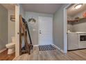 Convenient mud room featuring wood-look flooring, laundry area, and decor at 348 Southern Winds Blvd, Deland, FL 32720