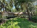 Beautiful exterior with lush landscaping and mature trees in a quiet neighborhood at 37 Meadowwood Trl, Deland, FL 32724