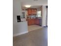 Bright kitchen features tile floor, wooden cabinets, and modern stainless steel appliances at 4830 Kempston Dr, Orlando, FL 32812