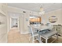 Charming dining room with seating for six and decorative lighting, adjacent to the kitchen for easy entertaining at 5300 S Atlantic Ave # 12-403, New Smyrna Beach, FL 32169